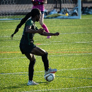 Girl kicking soccer ball